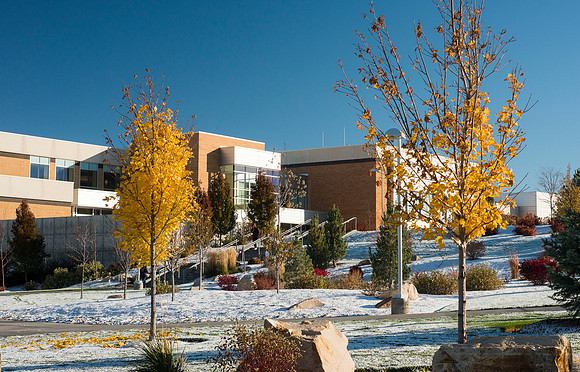 BYU-Idaho Manwaring Center framed in with a little autumn color and winter snow.