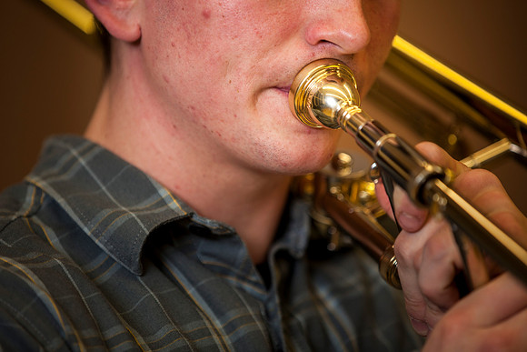 Roman Daves, a freshman at BYU-Idaho, practices with his trombone in the Snow Building.