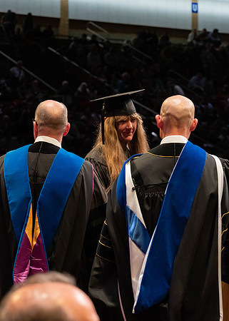 Students graduate and walk to receive their diplomas during convocation in the College of Physical Sciences and Engineering.