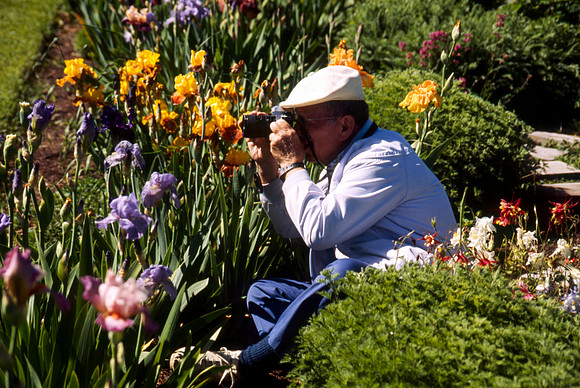 A man taking pictures of the Gardens' Flowers