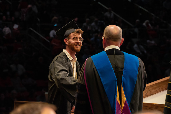 Students graduate and walk to receive their diplomas during convocation in the College of Physical Sciences and Engineering.