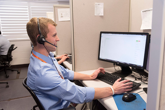 Employees work on developing a better curriculum for online students.