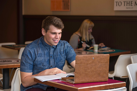 Blake Jensen studies for an Online class at the Cocoa Bean Cafe in Rexburg, ID.