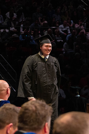 Students graduate and walk to receive their diplomas during convocation in the College of Physical Sciences and Engineering.
