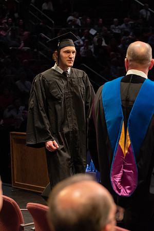 Students graduate and walk to receive their diplomas during convocation in the College of Physical Sciences and Engineering.