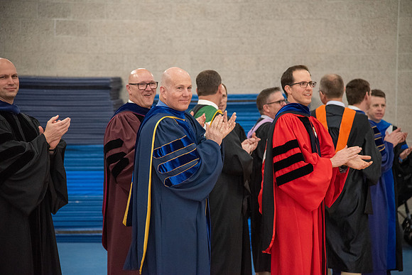 Student Graduates and Faculty meet in the I-Center for Commencement.