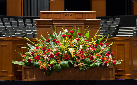 Floral Design students, Lauren Smith and Margaret Setterstrom create a beautiful floral arrangement in front of the podium for devotional.