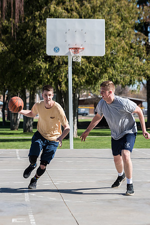 Jacob and Jacob, two BYU-Idaho students, play one on one basketball at the Smith Park court.