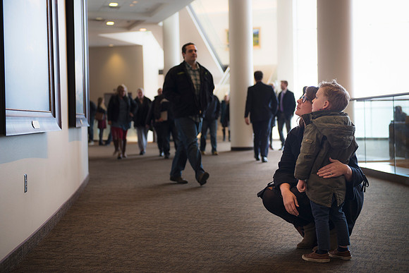 A mother pauses with her son to view the paintings of Christ on the second floor of the BYU-I Center after devotional.
