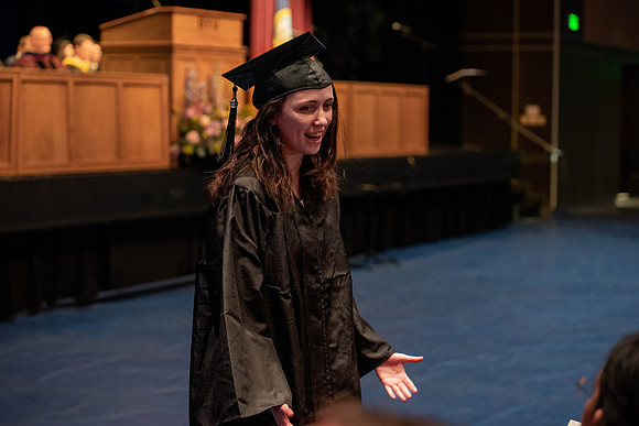 Students graduate and walk to receive their diplomas during convocation in the College of Physical Sciences and Engineering.