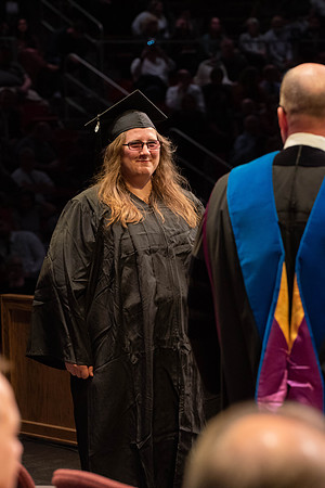 Students graduate and walk to receive their diplomas during convocation in the College of Physical Sciences and Engineering.