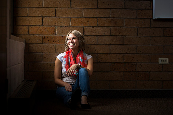 Maddie Crawford, a freshman from Wyoming, smiles as she looks up at the light coming through the window.