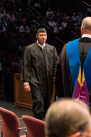Students graduate and walk to receive their diplomas during convocation in the College of Physical Sciences and Engineering.