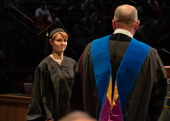 Students graduate and walk to receive their diplomas during convocation in the College of Physical Sciences and Engineering.