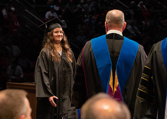 Students graduate and walk to receive their diplomas during convocation in the College of Physical Sciences and Engineering.