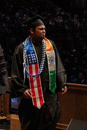 Students graduate and walk to receive their diplomas during convocation in the College of Physical Sciences and Engineering.