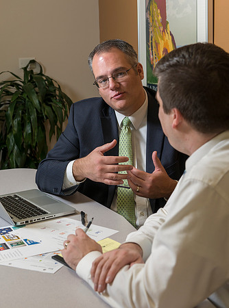 Arnold Thiebaud, Creative Services manager and Director of Marketing Communciations discusses a project with Jed Rhein the MarComm Graphic Designer.