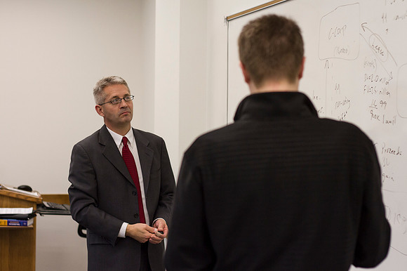 Brother Kevin Packard teaches examines a problem on the whiteboard as he teaches Intermediate Financial Accouting.