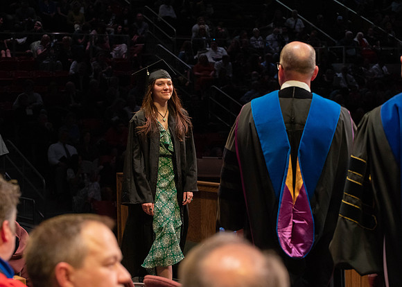 Students graduate and walk to receive their diplomas during convocation in the College of Physical Sciences and Engineering.
