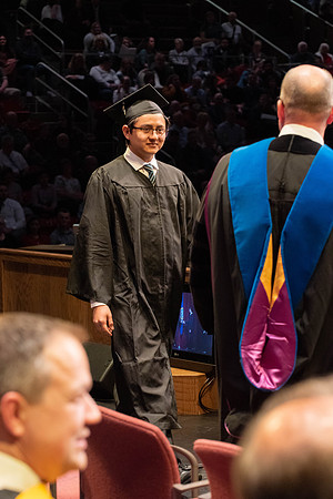 Students graduate and walk to receive their diplomas during convocation in the College of Physical Sciences and Engineering.