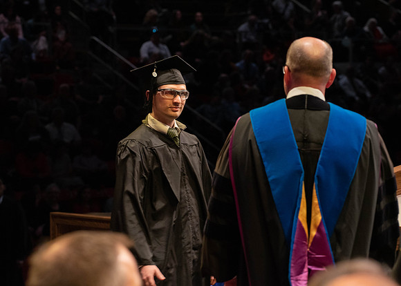 Students graduate and walk to receive their diplomas during convocation in the College of Physical Sciences and Engineering.