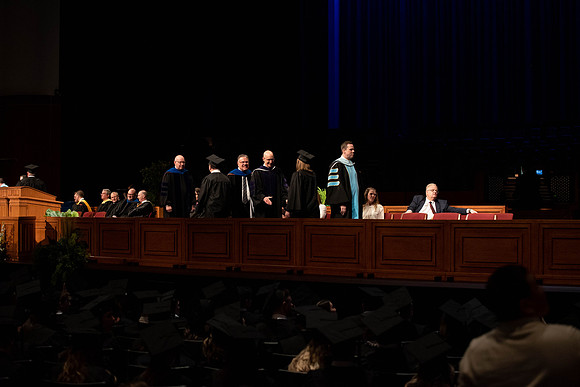 Students graduate and walk to recieve their diplomas during convocation in the College of Business and Communications.
