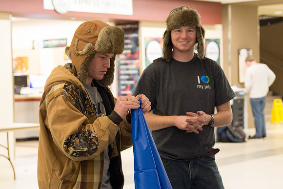 Students learn to make hammocks out of parachute material.