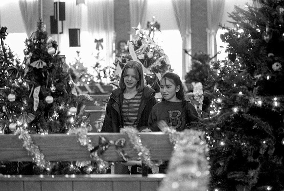 Two youngs girls looking at the Christmas decorations