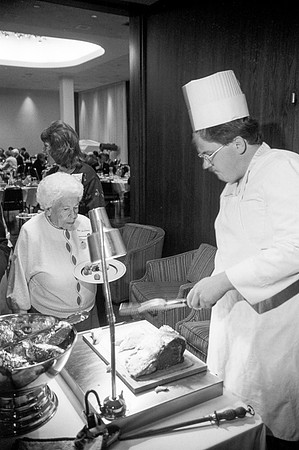 Guests at the President's Club Banquet getting food.