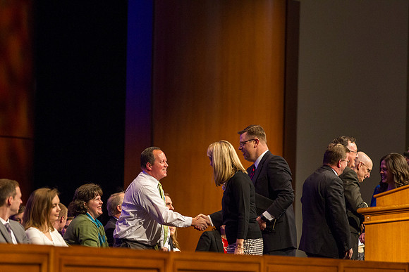 President Gilbert shakes hands with Michael Ballard before devotional begins.