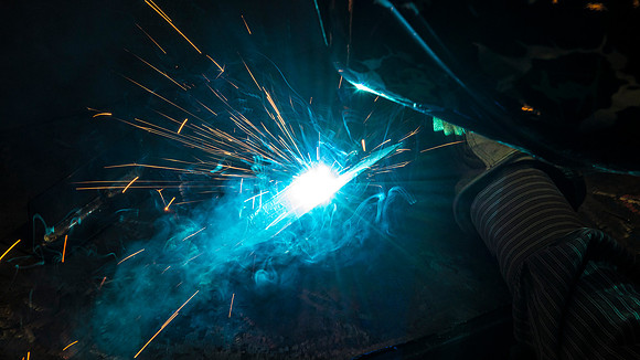 Clay Rasmussen, from the Mechanical Engineering Department, welds during a demonstration.