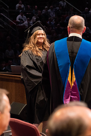 Students graduate and walk to receive their diplomas during convocation in the College of Physical Sciences and Engineering.