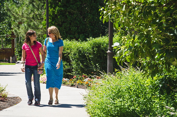 A mother and her daughter walk through the Thomas E. Ricks Gardens toward the Gordon B. Hinckley Building for classes offered during Education Week 2013. Photo by Taylor Davenport