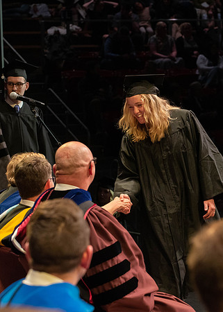 Students graduate and walk to receive their diplomas during convocation in the College of Physical Sciences and Engineering.