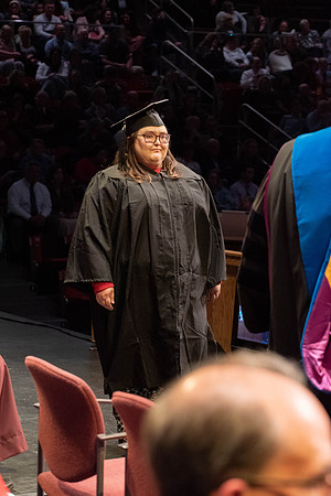 Students graduate and walk to receive their diplomas during convocation in the College of Physical Sciences and Engineering.