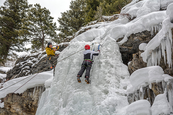 Scott Hurst (left) takes a picture of Megan Asplund (right) ice climbing.