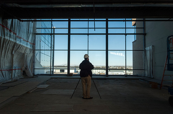 Mike Lewis, head of University Relations Photography, take pictures inside the new Science Technology Building.