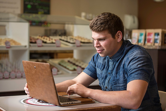 Blake Jensen studies for an Online class at the Cocoa Bean Cafe in Rexburg, ID.