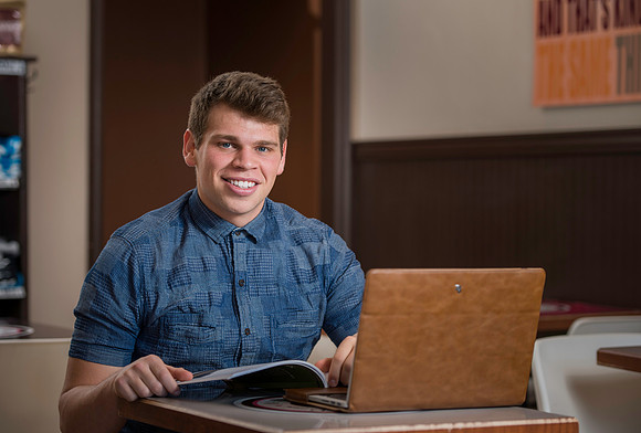 Blake Jensen studies for an Online class at the Cocoa Bean Cafe in Rexburg, ID.