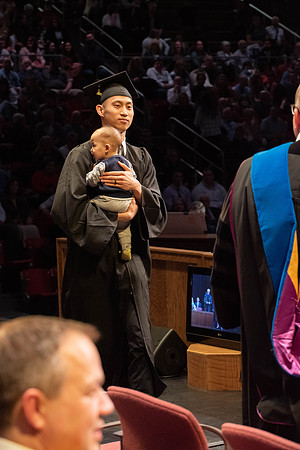 Students graduate and walk to receive their diplomas during convocation in the College of Physical Sciences and Engineering.