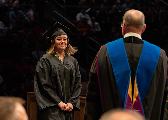 Students graduate and walk to receive their diplomas during convocation in the College of Physical Sciences and Engineering.