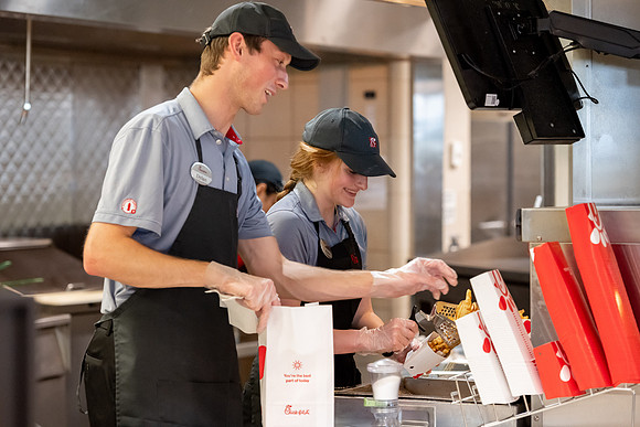 Employees of the Chick-Fil-A on the BYU-Idaho campus working and helping students.