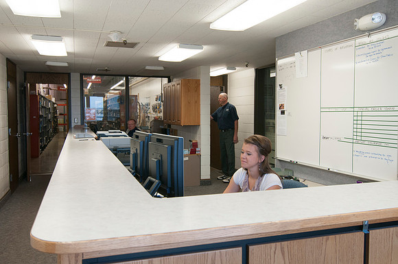 Employees, Kara Barnes, Ron Green, &amp; Gary Romerjo working at mail services