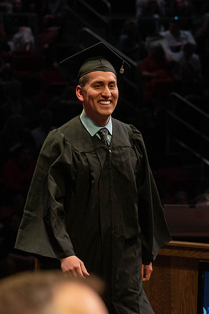 Students graduate and walk to receive their diplomas during convocation in the College of Physical Sciences and Engineering.