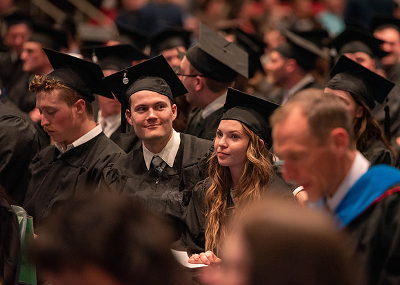 Students graduate and walk to receive their diplomas during convocation in the College of Physical Sciences and Engineering.