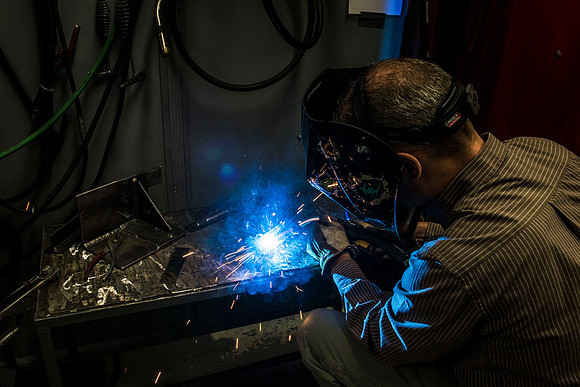 Clay Rasmussen, from the Mechanical Engineering Department, welds during a demonstration.