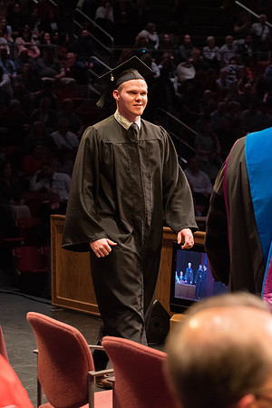 Students graduate and walk to receive their diplomas during convocation in the College of Physical Sciences and Engineering.