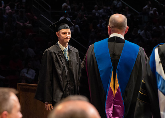 Students graduate and walk to receive their diplomas during convocation in the College of Physical Sciences and Engineering.