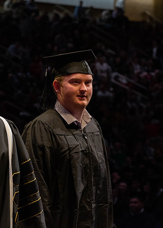Students graduate and walk to receive their diplomas during convocation in the College of Physical Sciences and Engineering.