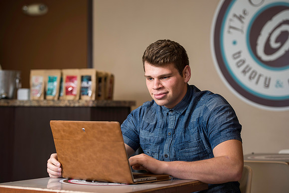 Blake Jensen studies for an Online class at the Cocoa Bean Cafe in Rexburg, ID.